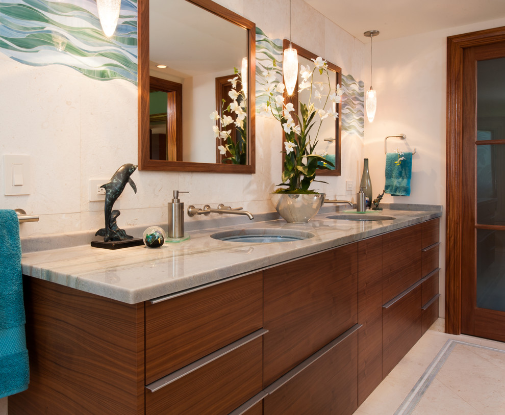 Tropical bathroom in Hawaii with flat-panel cabinets, medium wood cabinets, an open shower, a one-piece toilet, white tile, stone tile, beige walls, limestone floors, an undermount sink and quartzite benchtops.