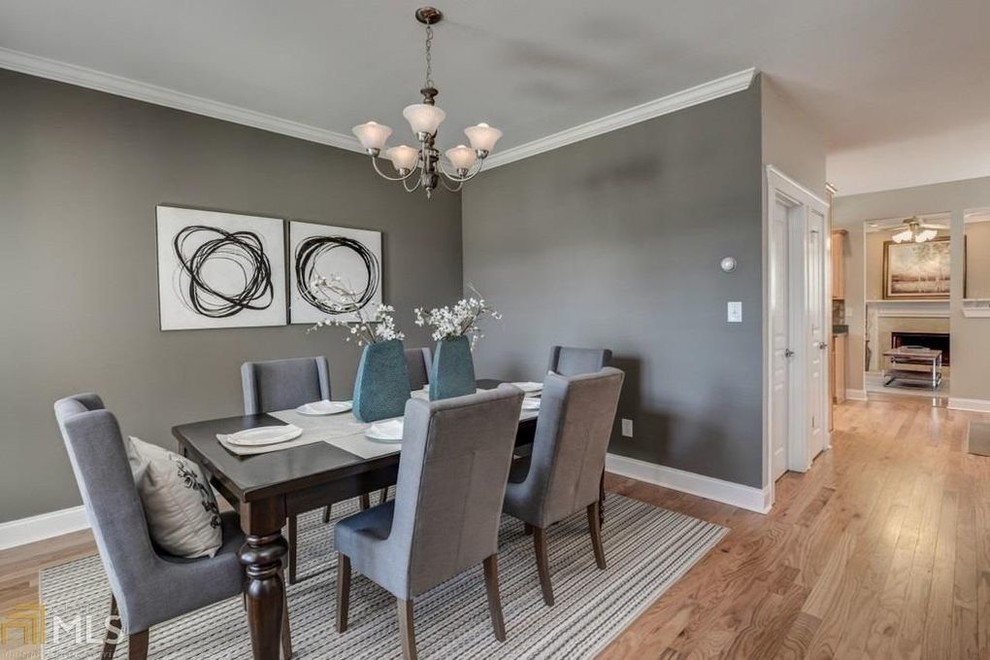 Mid-sized transitional medium tone wood floor and brown floor great room photo with gray walls