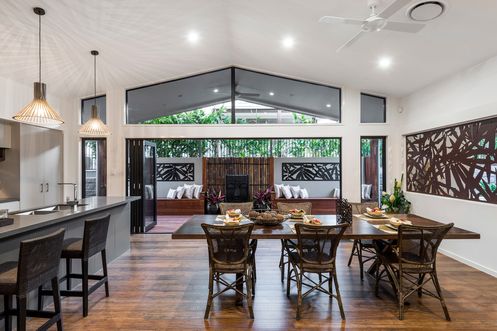 Mid-sized contemporary kitchen/dining combo in Brisbane with white walls, bamboo floors and no fireplace.