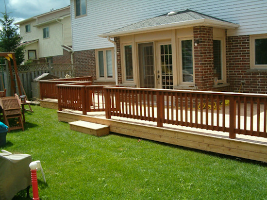 Example of a large backyard deck design in Toronto with no cover