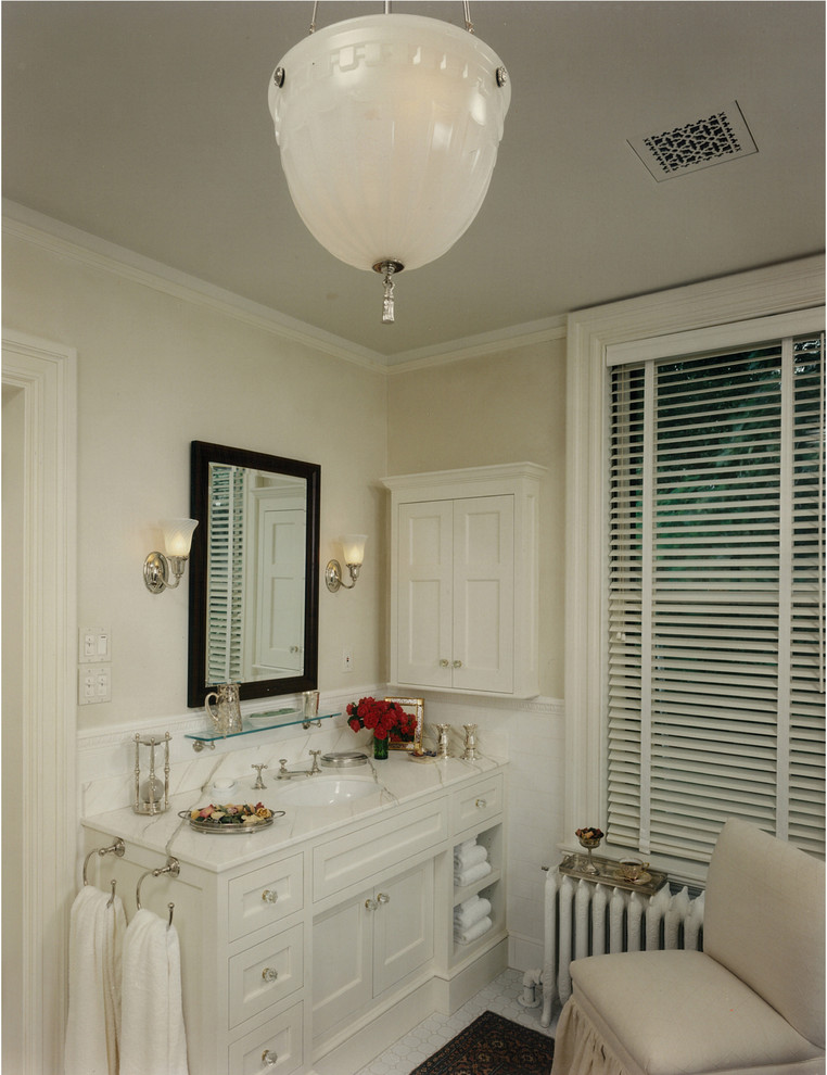 Traditional bathroom in Boston with an undermount sink, shaker cabinets, white cabinets and white tile.
