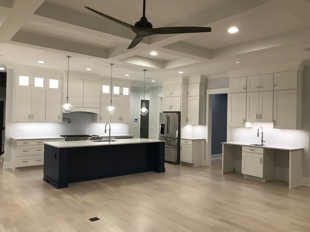 Mid-sized transitional l-shaped light wood floor and beige floor open concept kitchen photo in Cincinnati with an undermount sink, shaker cabinets, white cabinets, granite countertops, stainless steel appliances, an island and gray countertops