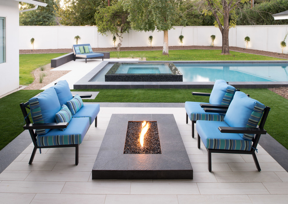 Design ideas for a large contemporary backyard rectangular lap pool in Phoenix with tile.