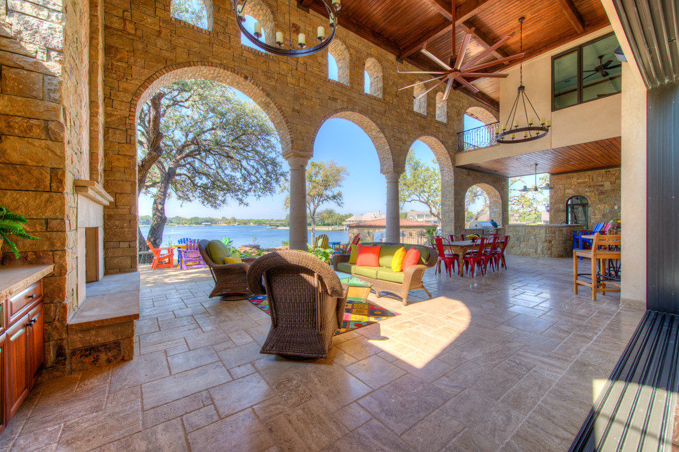 This is an example of a mediterranean patio in Austin with an outdoor kitchen.