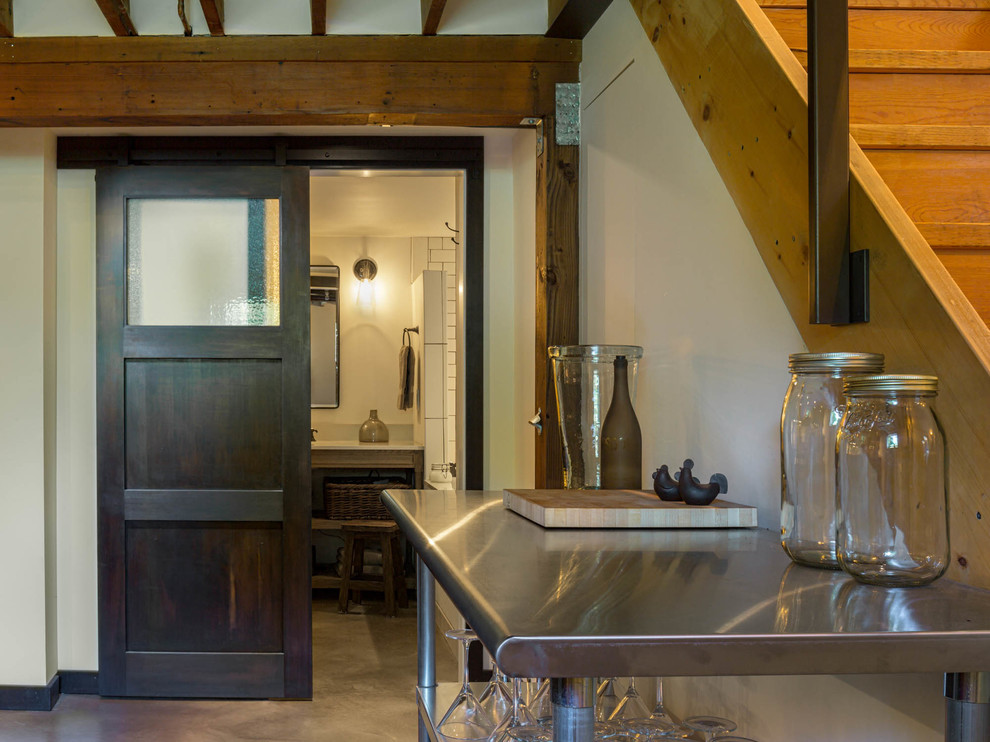 Inspiration for a mid-sized transitional single-wall concrete floor home design remodel in Seattle with stainless steel countertops