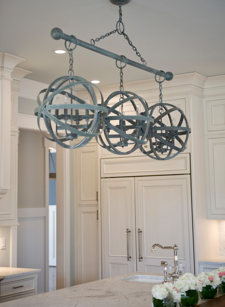 Inspiration for a transitional kitchen remodel with an undermount sink, recessed-panel cabinets, white cabinets, marble countertops, white backsplash, mosaic tile backsplash, stainless steel appliances and an island