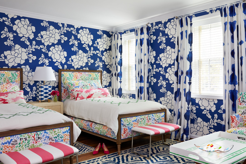 Country guest bedroom in DC Metro with blue walls, medium hardwood floors and brown floor.