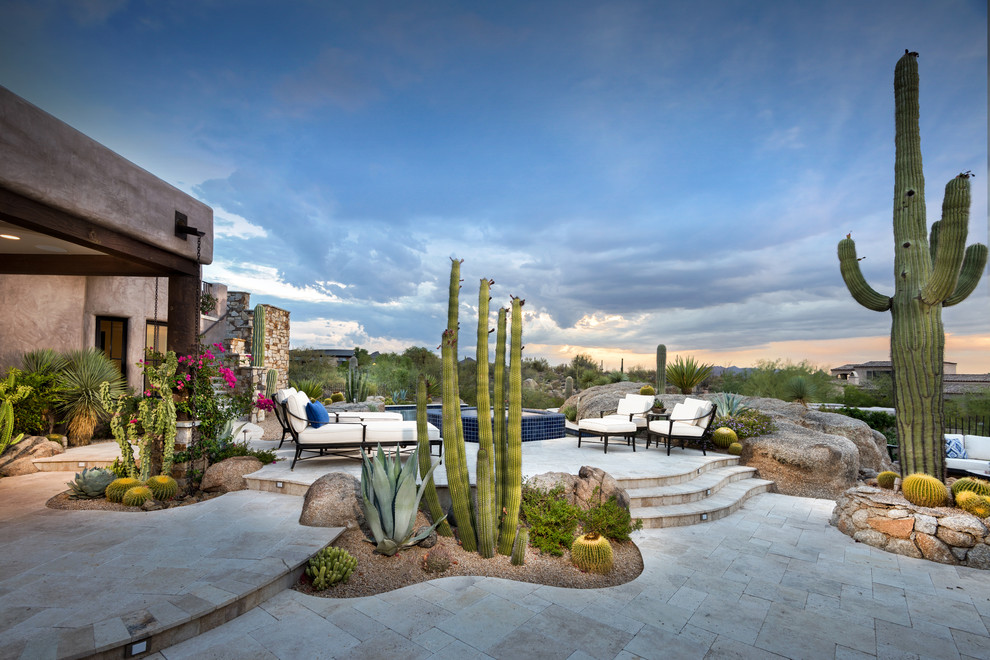 Expansive backyard patio in Phoenix with natural stone pavers.