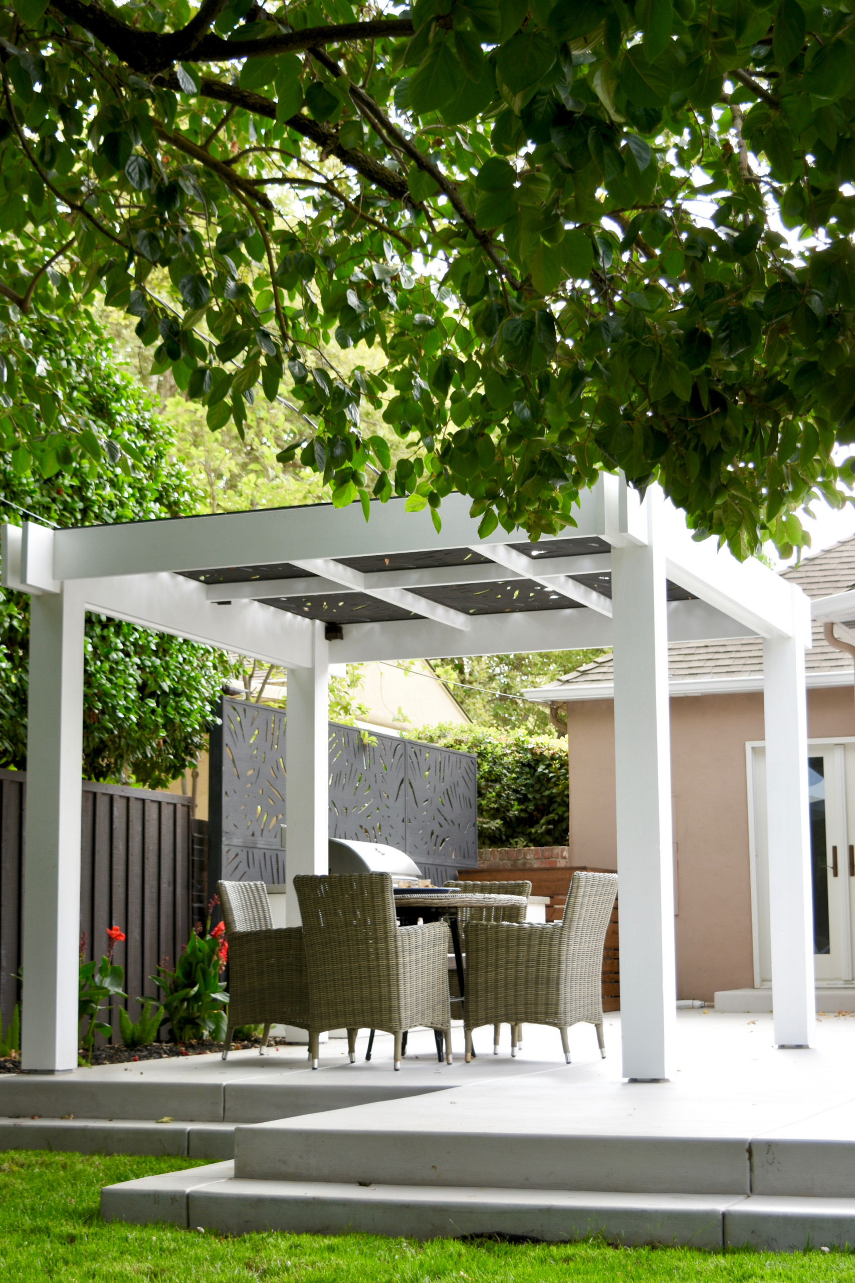 Daytime View of Pergola, Dining Area, and Outdoor Kitchen Privacy Screen