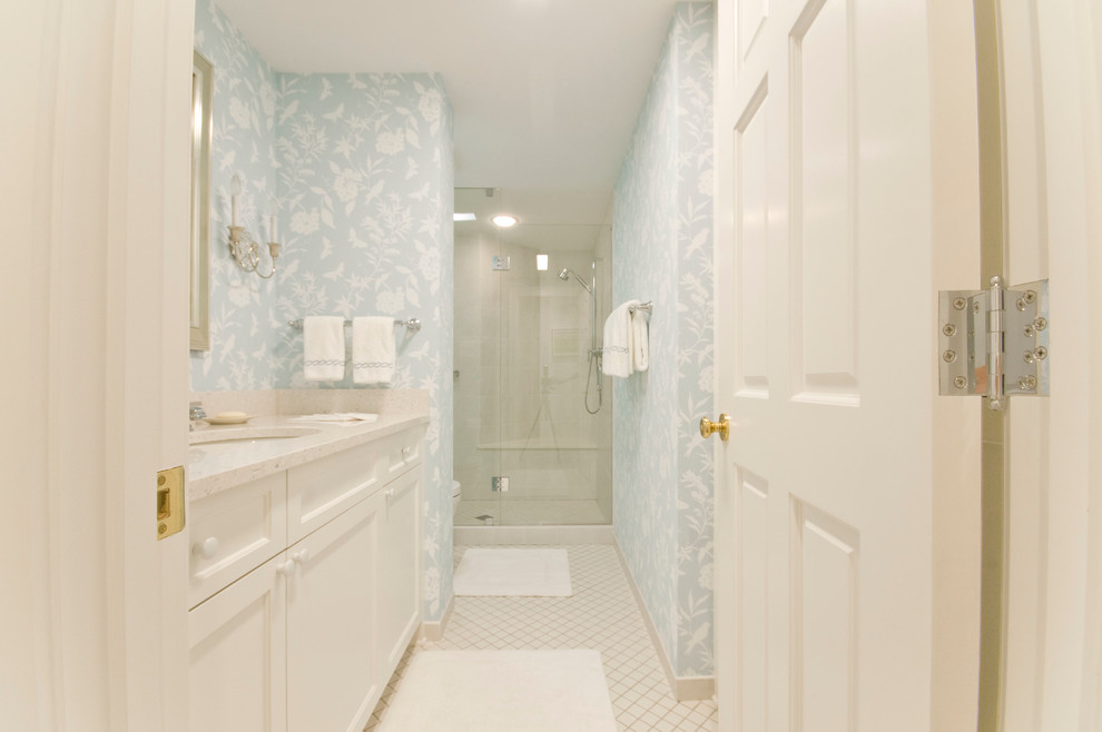 This is an example of a mid-sized traditional master bathroom in Minneapolis with an undermount sink, recessed-panel cabinets, white cabinets, granite benchtops, an alcove shower, a one-piece toilet, white tile and grey walls.