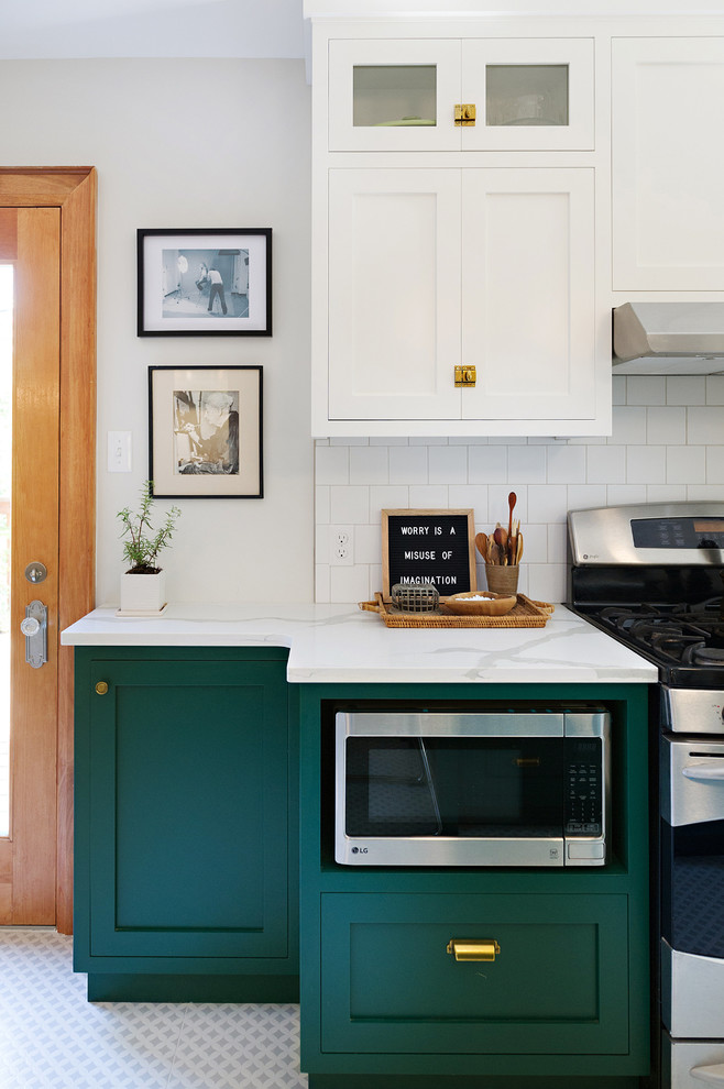 Enclosed kitchen - large transitional porcelain tile and multicolored floor enclosed kitchen idea with a drop-in sink, shaker cabinets, white cabinets, marble countertops, white backsplash, ceramic backsplash, stainless steel appliances and an island