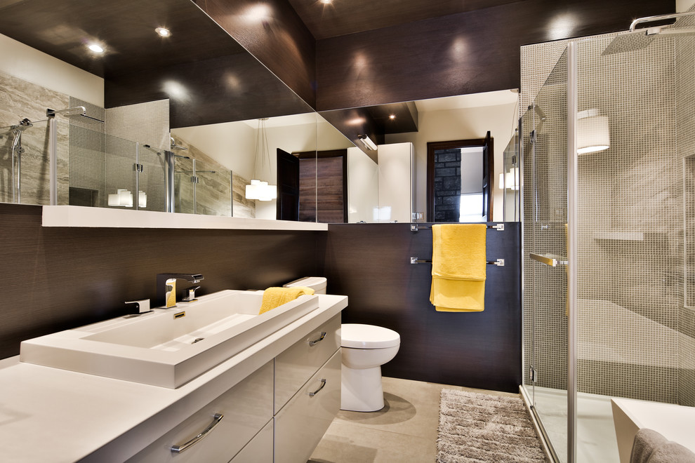 Design ideas for a contemporary 3/4 bathroom with flat-panel cabinets, white cabinets, a corner shower, gray tile, mosaic tile, brown walls, a trough sink, beige floor and a hinged shower door.