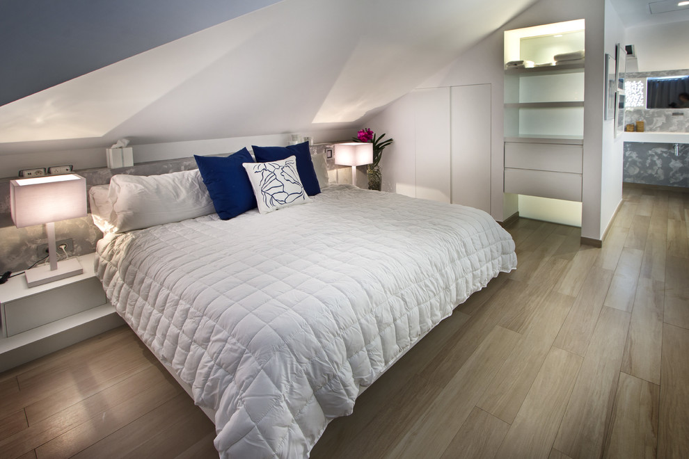 Design ideas for a mid-sized contemporary bedroom in Other with white walls and light hardwood floors.