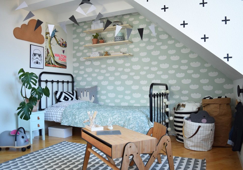 Inspiration for a mid-sized scandinavian gender-neutral kids' playroom for kids 4-10 years old in Aarhus with multi-coloured walls and light hardwood floors.