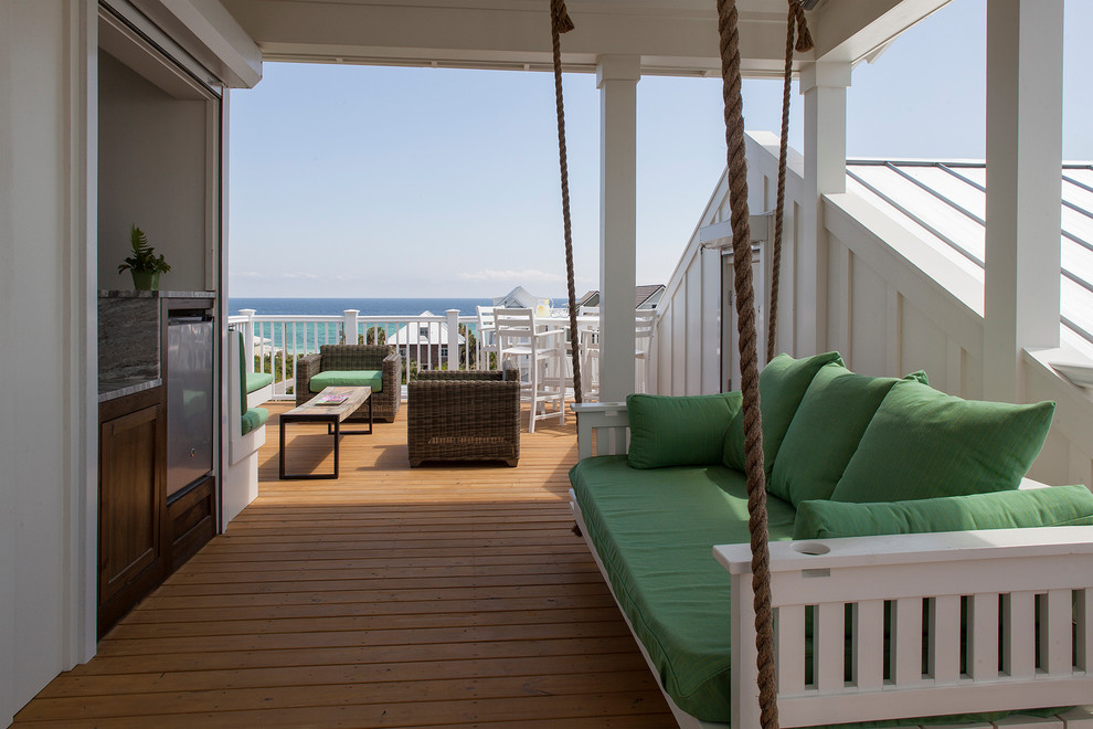 Inspiration for a mid-sized beach style rooftop deck in Jacksonville with an outdoor kitchen and a pergola.