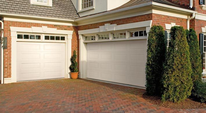 This is an example of a large transitional attached two-car garage in Boston.