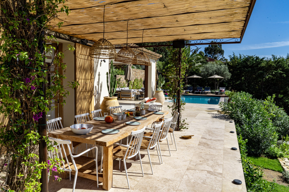 Imagen de patio mediterráneo grande en patio delantero con jardín de macetas, suelo de baldosas y pérgola