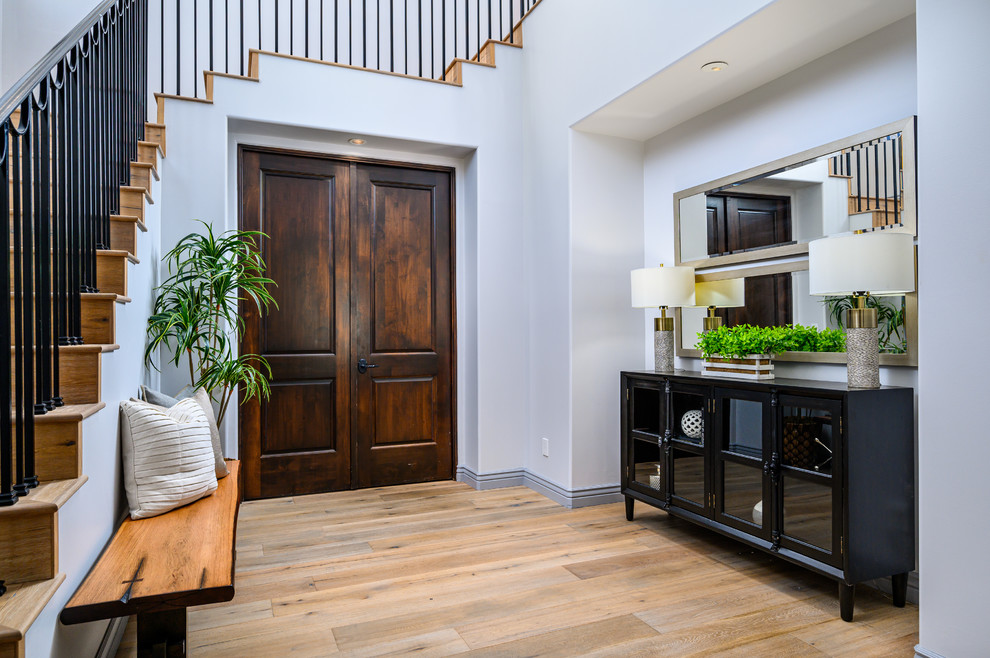 Inspiration for a large transitional light wood floor foyer remodel in Phoenix with gray walls and a black front door