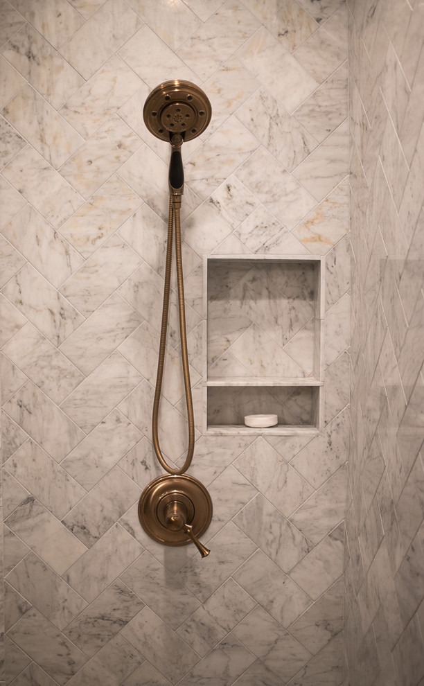 Inspiration for a large transitional master white tile and marble tile porcelain tile and gray floor corner shower remodel with shaker cabinets, dark wood cabinets, an undermount tub, a one-piece toilet, brown walls, an undermount sink, quartz countertops, a hinged shower door and white countertops