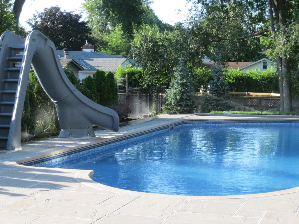Pool - large backyard stone pool idea in Toronto