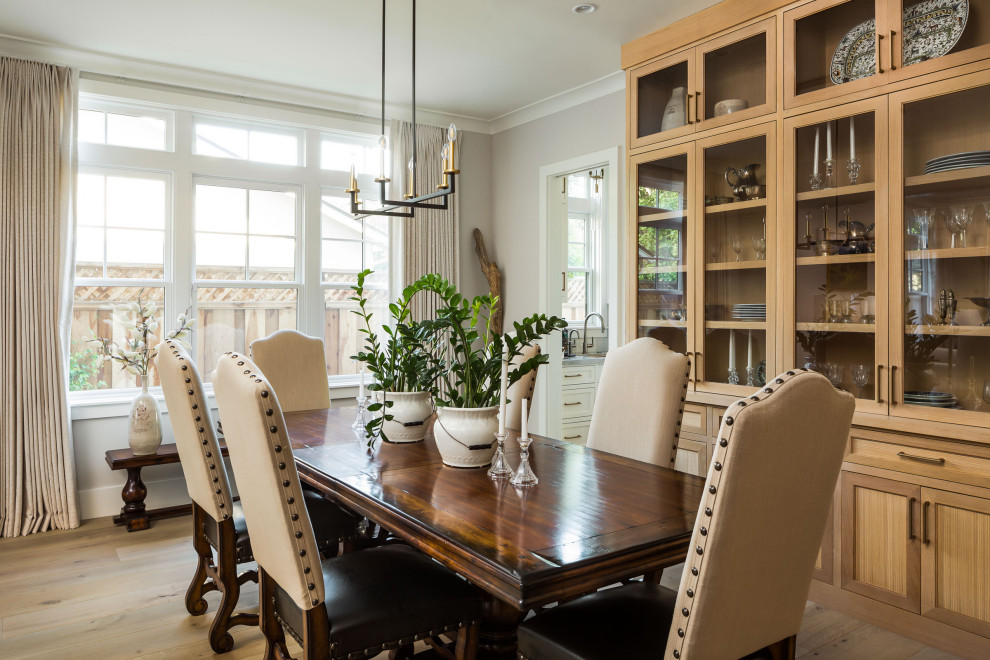 This is an example of a mid-sized transitional separate dining room in San Francisco with grey walls, medium hardwood floors and grey floor.