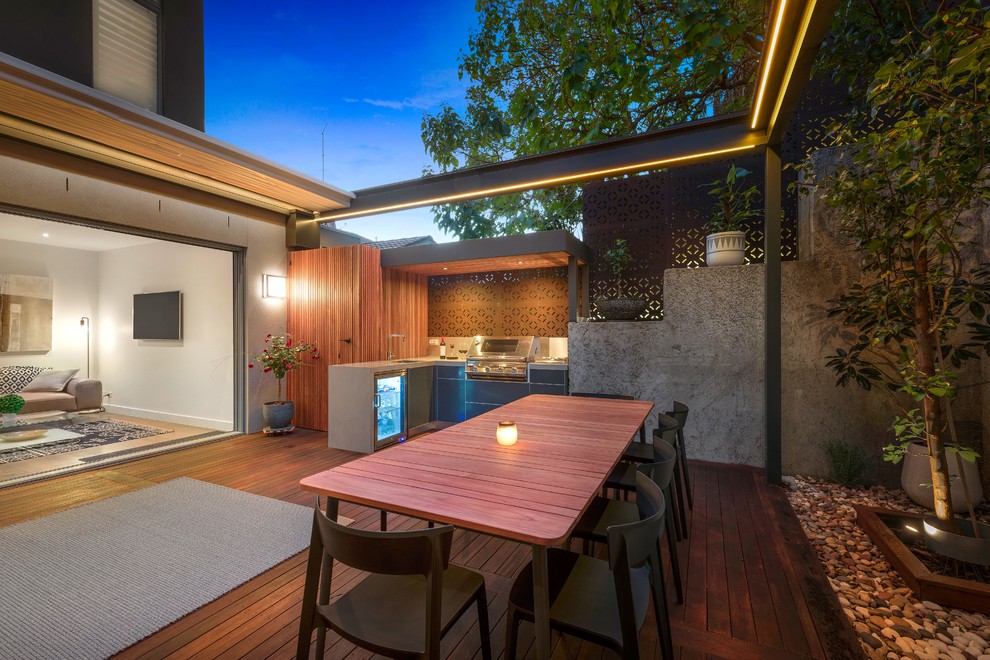 Design ideas for a mid-sized contemporary backyard deck in Melbourne with an outdoor kitchen and a pergola.