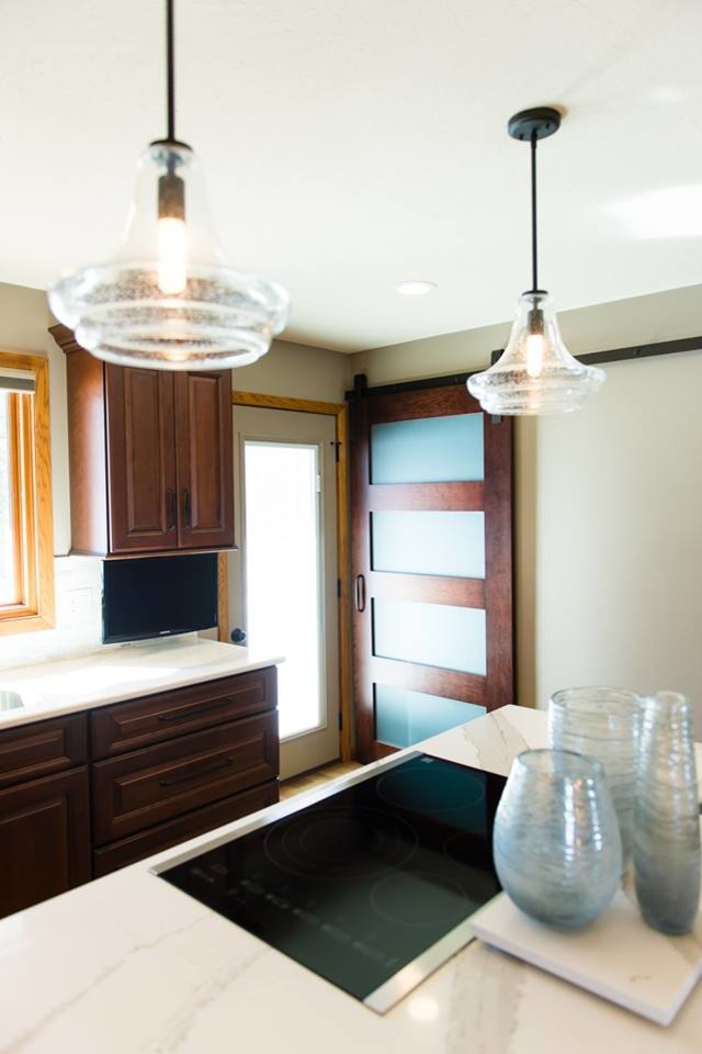 Transitional ceramic tile and brown floor eat-in kitchen photo with brown cabinets, quartzite countertops, beige backsplash, ceramic backsplash, stainless steel appliances, an island and white countertops