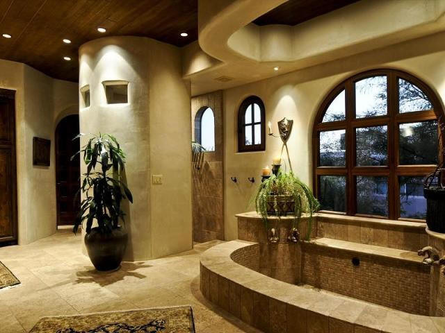 Mediterranean bathroom in Phoenix with an undermount sink and stone tile.