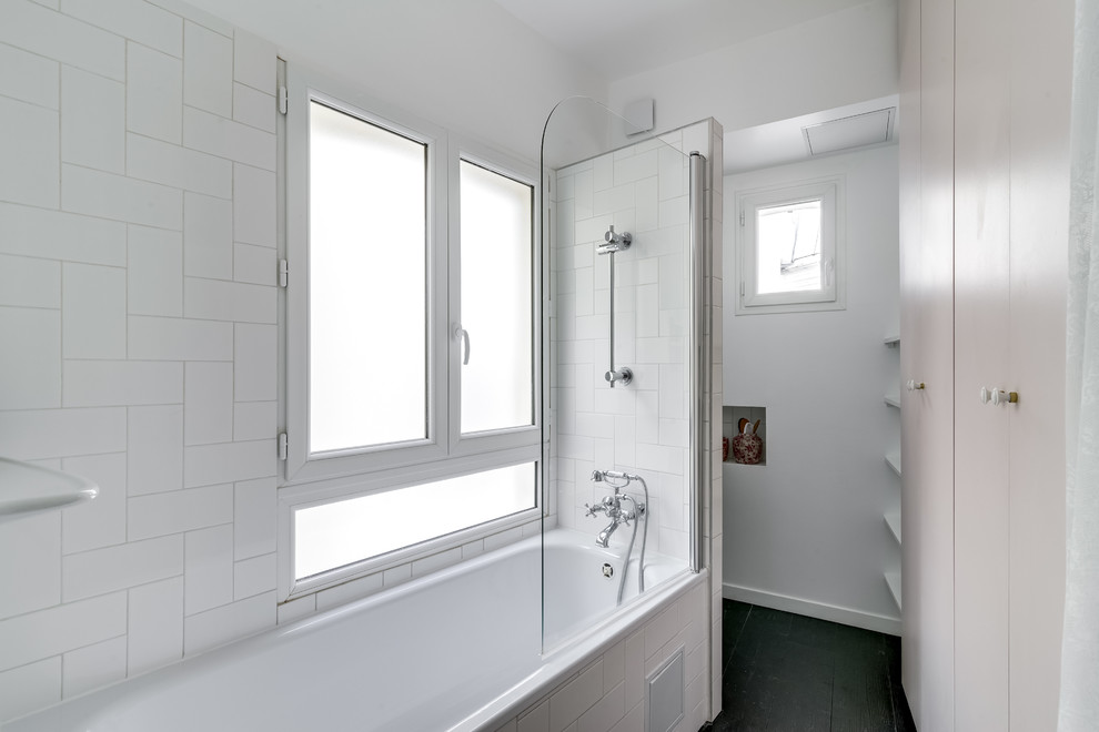 This is an example of a small midcentury master bathroom in Paris with flat-panel cabinets, a drop-in tub, a shower/bathtub combo, white tile, porcelain tile and white walls.