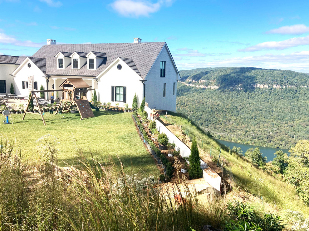 Photo of a huge traditional full sun backyard flower bed in Other for winter.