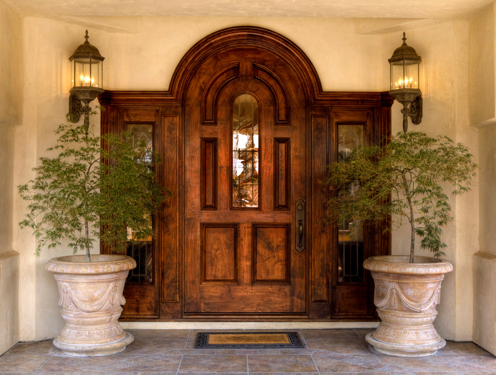 Photo of a large traditional front door in Other with beige walls, porcelain floors, a single front door and a dark wood front door.
