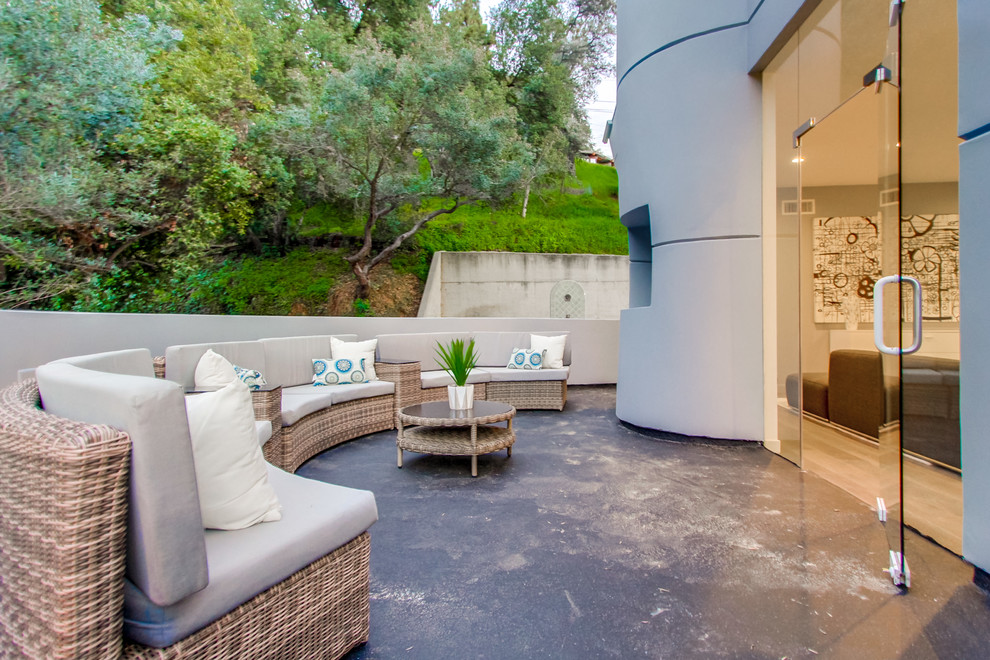 This is an example of a mid-sized contemporary backyard patio in Los Angeles with concrete slab and no cover.