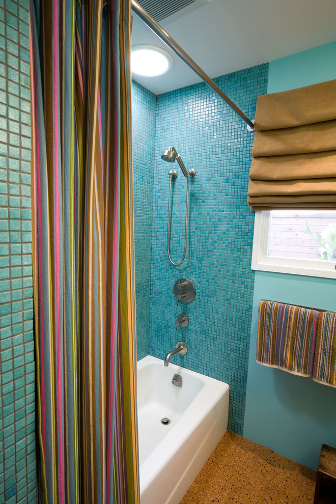 Photo of a small contemporary bathroom in San Luis Obispo with an integrated sink, flat-panel cabinets, medium wood cabinets, concrete benchtops, an open shower, a two-piece toilet, blue tile, brown walls and cork floors.