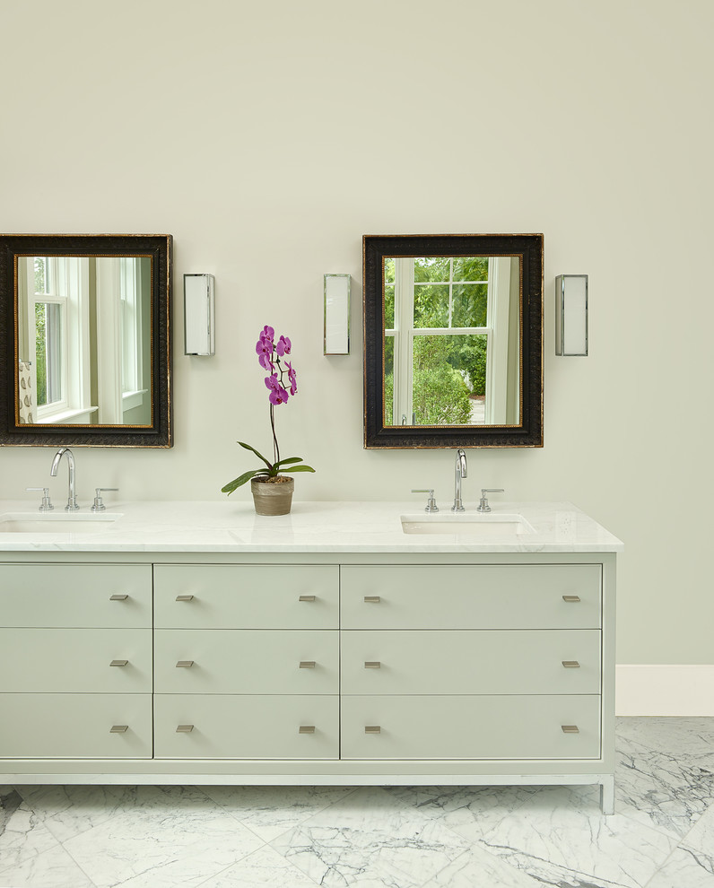 This is an example of a mid-sized modern master bathroom in Charleston with an undermount sink, flat-panel cabinets, marble benchtops, a freestanding tub, a one-piece toilet, white tile, stone tile, marble floors, grey cabinets, an alcove shower and beige walls.