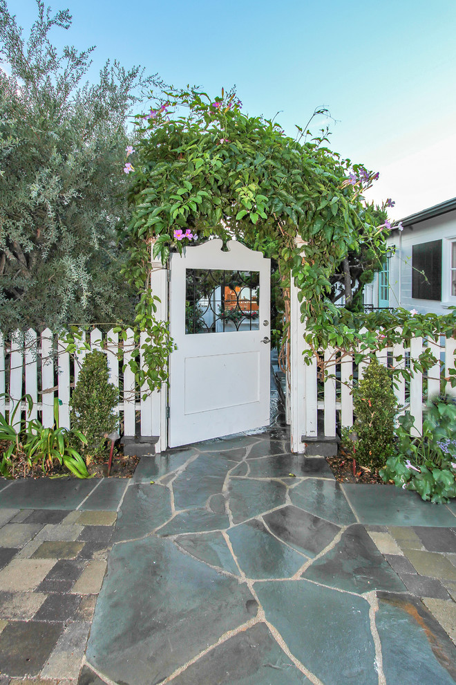 This is an example of a beach style garden in Orange County with a garden path.