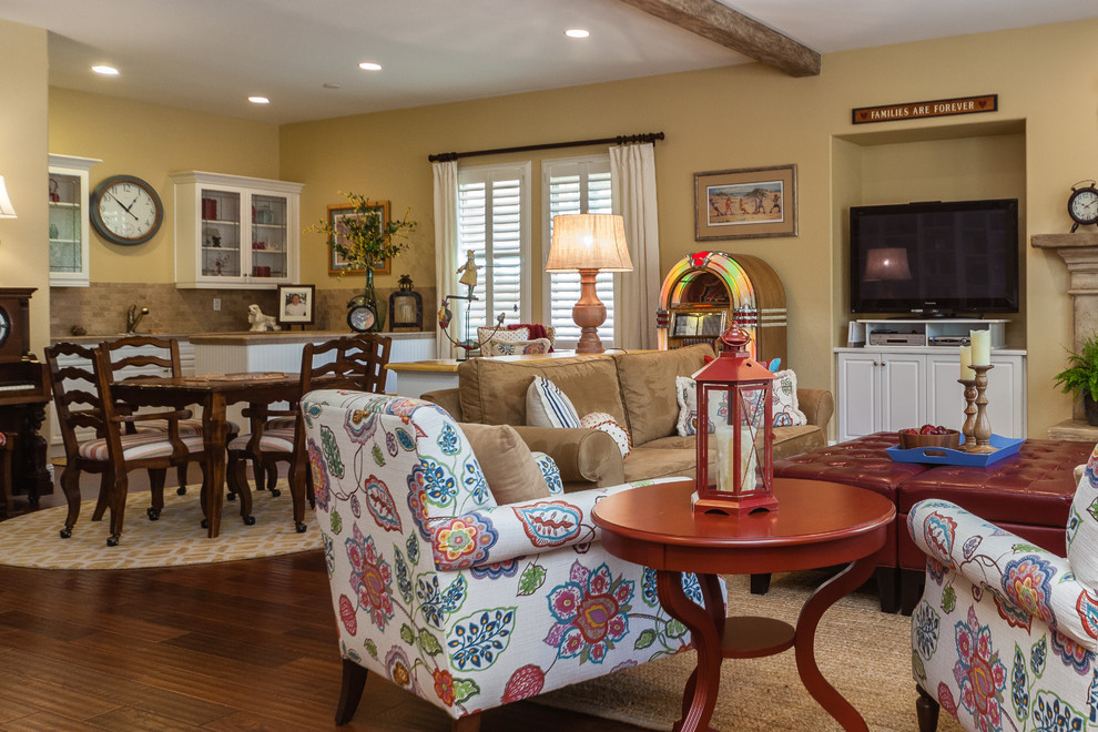 Inspiration for a large eclectic open concept family room in Other with yellow walls, medium hardwood floors, a standard fireplace, a stone fireplace surround, no tv and brown floor.