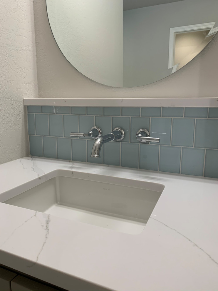 Inspiration for a large transitional master bathroom in Oklahoma City with shaker cabinets, grey cabinets, a curbless shower, blue tile, grey walls, an undermount sink, engineered quartz benchtops, a hinged shower door, white benchtops, a shower seat, a double vanity and a built-in vanity.