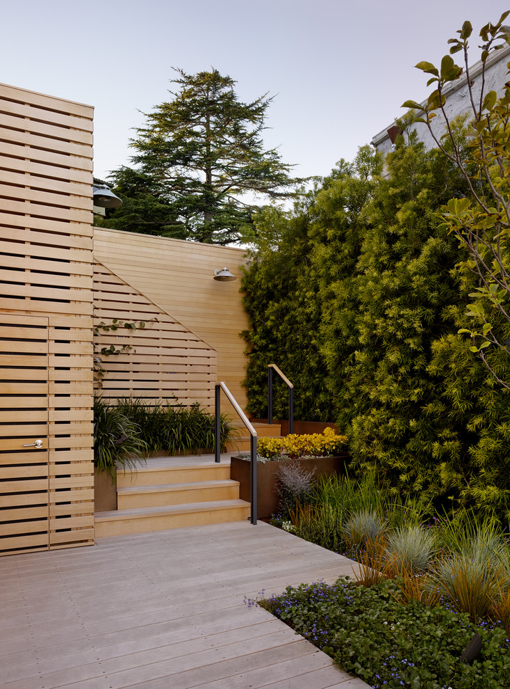 This is an example of a mid-sized contemporary backyard deck in San Francisco with a vertical garden and no cover.