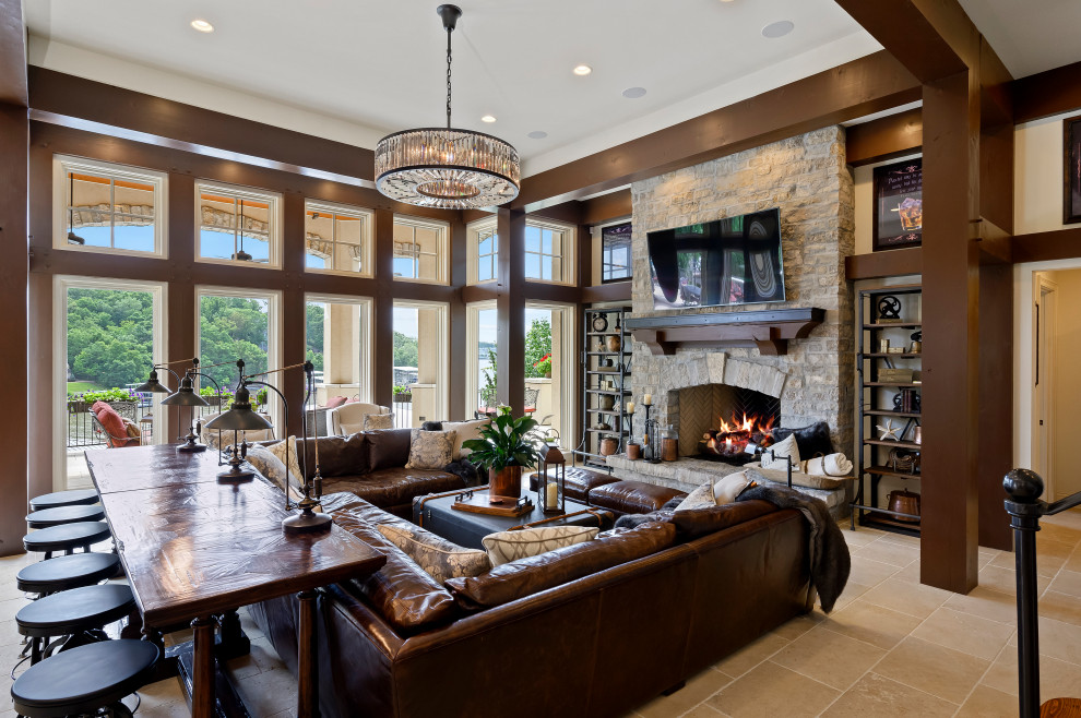 Mediterranean living room in Kansas City with white walls, a standard fireplace, a stone fireplace surround and beige floor.