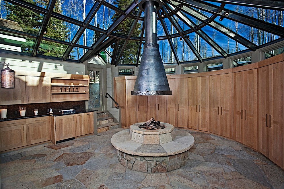 This is an example of a transitional sunroom in Denver with a glass ceiling.
