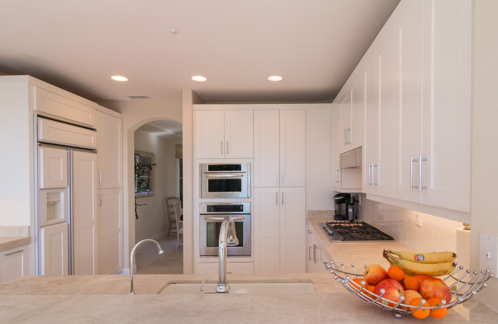 Inspiration for a contemporary kitchen in Orange County with shaker cabinets, white cabinets and marble benchtops.