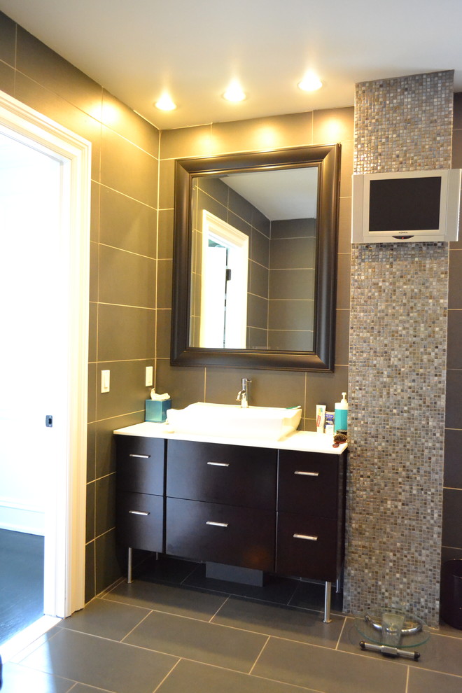 Bathroom - large transitional master gray tile and mosaic tile porcelain tile and gray floor bathroom idea with flat-panel cabinets, dark wood cabinets, gray walls, a vessel sink, solid surface countertops and white countertops