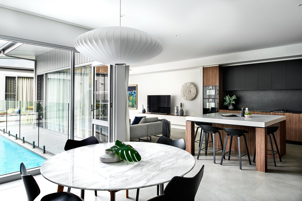Inspiration for a contemporary open plan dining in Sydney with white walls and grey floor.