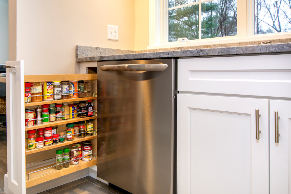 Example of a ceramic tile and gray floor kitchen design in Boston with recessed-panel cabinets, white cabinets, quartzite countertops, white backsplash, stainless steel appliances and an island