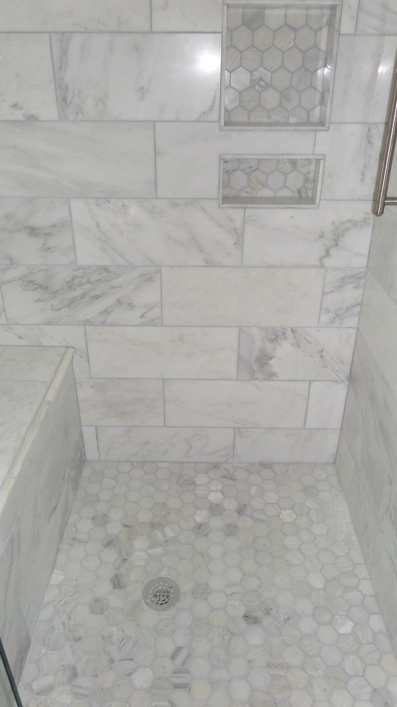 This is an example of a mid-sized modern master bathroom in Atlanta with shaker cabinets, black cabinets, a claw-foot tub, an alcove shower, a one-piece toilet, gray tile, white tile, porcelain tile, grey walls, marble floors, an undermount sink and solid surface benchtops.