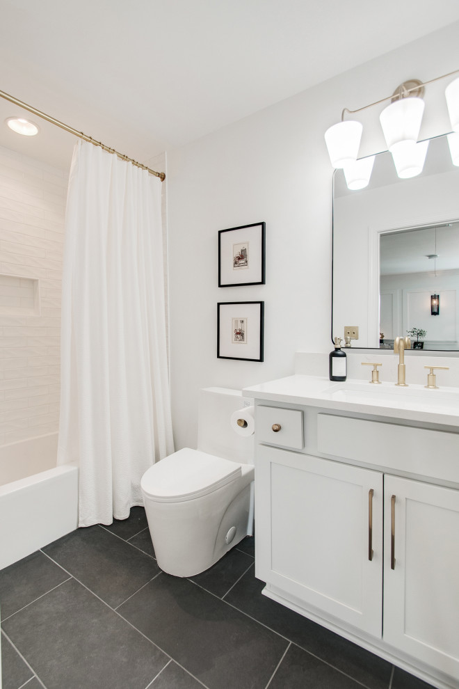 Small midcentury family bathroom in Nashville with shaker cabinets, white cabinets, a one-piece toilet, multi-coloured tiles, ceramic tiles, white walls, ceramic flooring, a submerged sink, engineered stone worktops, a hinged door, white worktops, double sinks and a built in vanity unit.