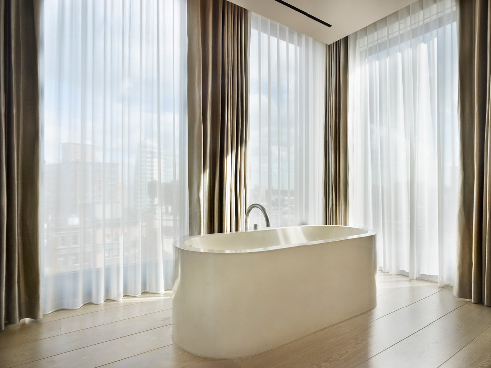 Photo of a contemporary bathroom in New York with a freestanding tub.