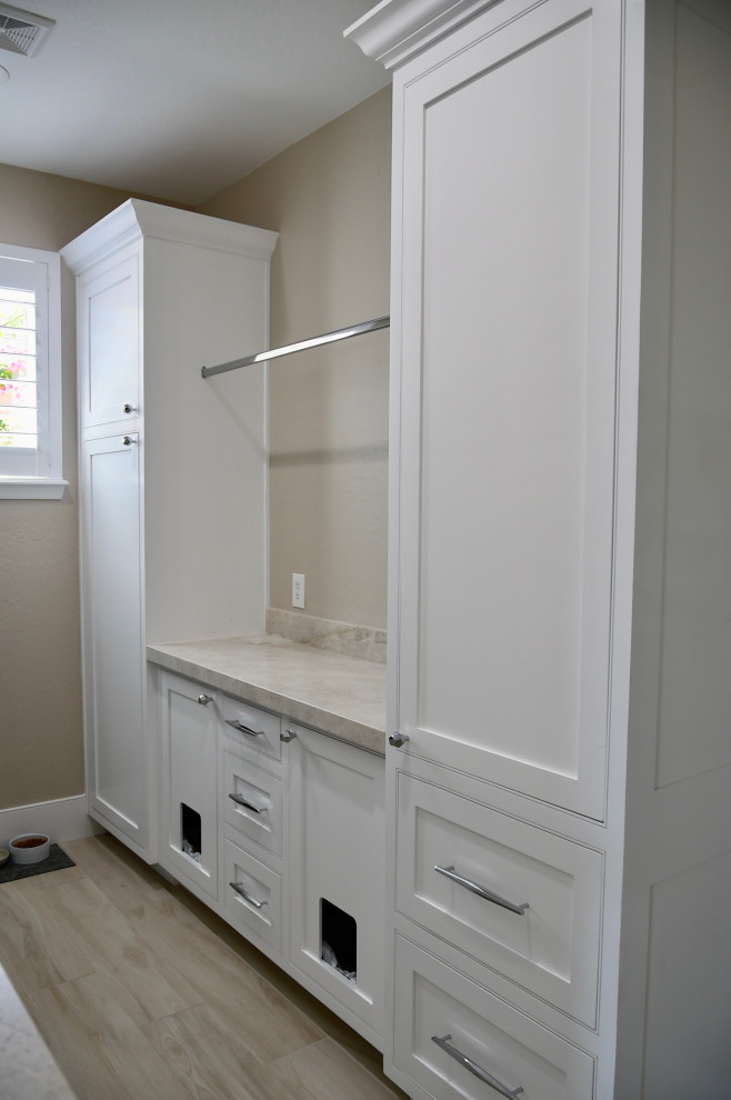 Photo of a mid-sized transitional u-shaped utility room in Phoenix with an undermount sink, shaker cabinets, white cabinets, quartzite benchtops, beige walls, porcelain floors, a side-by-side washer and dryer, beige floor and beige benchtop.