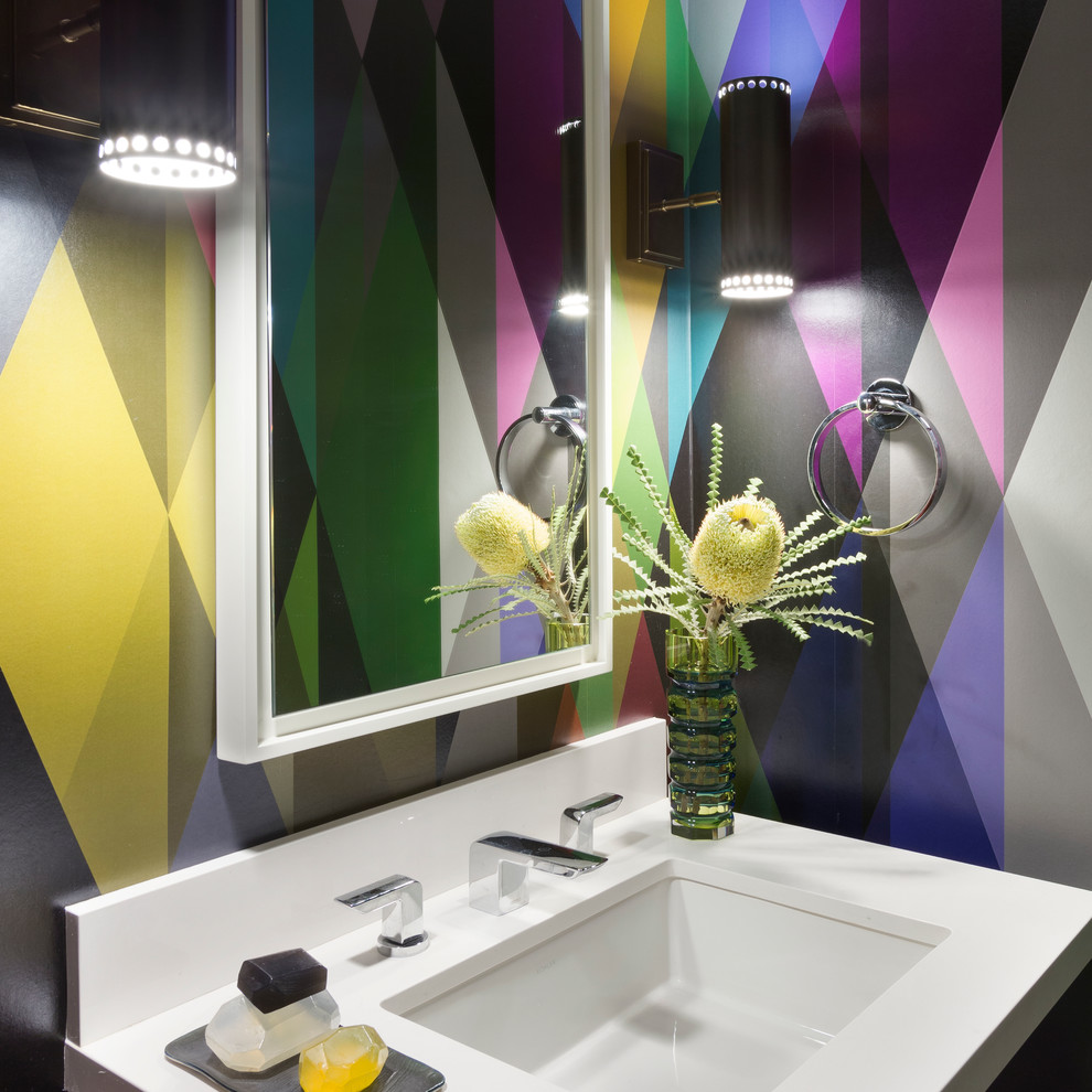 Contemporary powder room in Los Angeles with an undermount sink, multi-coloured walls and white benchtops.