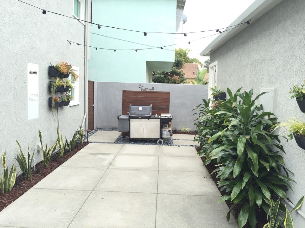 Design ideas for a large beach style backyard patio in Orange County with a fire feature, concrete slab and no cover.